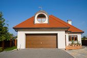stock photo of blue sky  - Single family white house with garage gate over blue sky - JPG 
