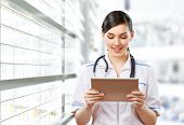 stock photo of medical doctors  - a woman holding a tablet pc - JPG 