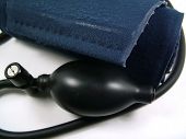 stock photo of bloodpressure  - a blood pressure cuff rolled up over white background - JPG 