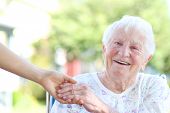 picture of holding  - Happy senior woman holding hands with caretaker - JPG 