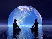 foto of earth  - Two human silouhettes meditating in front of the earth by night - JPG 