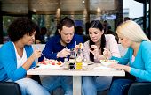 image of restaurant  - Group of teenagers students on lunch in restaurant - JPG 