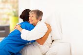 picture of hug  - happy elderly woman hugging caregiver on bed - JPG 
