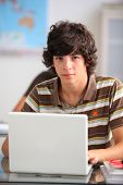 foto of computer  - Portrait of a teenager in front of a laptop computer - JPG 