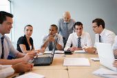 picture of meeting  - Portrait of business people in suit in a meeting room with laptop computers - JPG 