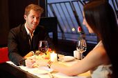 stock photo of restaurant  - The restaurant guy holding a beautiful Brunette by the hand - JPG 