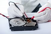 image of disk  - A technician repairing an hard disk with a tester - JPG 