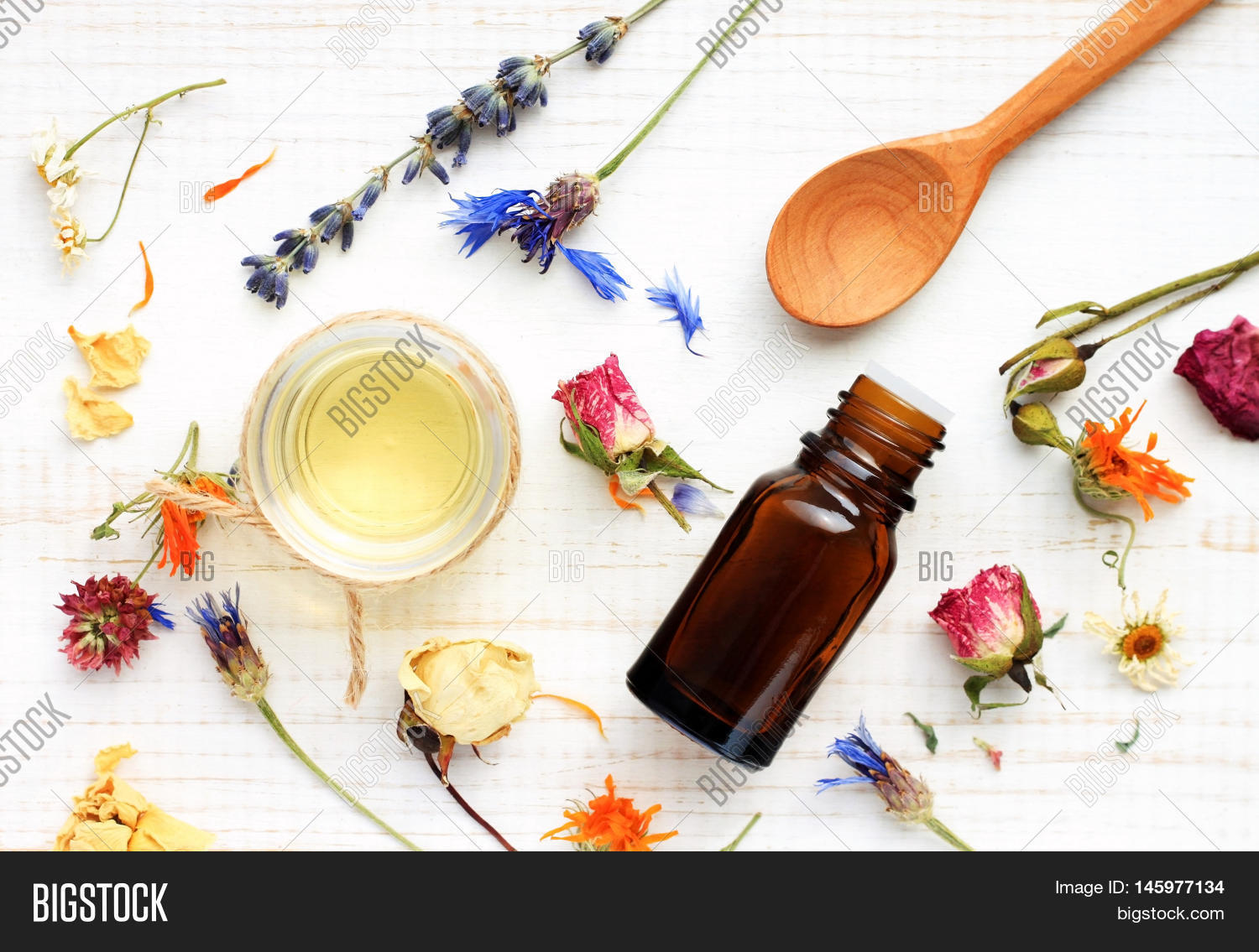 Essential oil, medicinal plant mix, herbal skincare ingredients. Top view Aroma dropper bottle