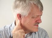 pic of pressure  - a senior man suffers from pressure behind his ear - JPG 