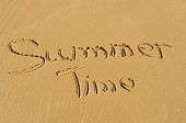 picture of time  - concept summer time written in the sand of a beach - JPG 