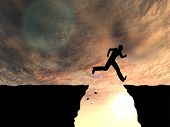 stock photo of gap  - Concept or conceptual young man or businessman silhouette jump happy from cliff over  gap sunset or sunrise sky background - JPG 