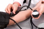 pic of pressure  - doctor checking blood pressure with stethoscope and sphygmomanometer - JPG 