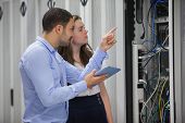 image of cord  - Technicians looking at servers in data center using tablet pc - JPG 