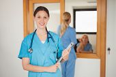 picture of entrance  - Intern holding a clipboard in hospital entrance - JPG 