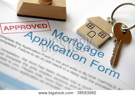 Picture or Photo of Approved Mortgage loan application with house key and rubber stamp