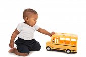 picture of boy  - Little African American Baby Boy Pushing Toy School Bus on White Background - JPG 