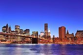 foto of bridge  - Brooklyn bridge with New York City Manhattan downtown skyline at dusk illuminated over East River with blue clear sky - JPG 
