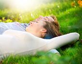stock photo of outdoor  - Happy Smiling Couple Relaxing on Green Grass - JPG 