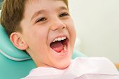 pic of youngster  - Photo of youngster with his mouth wide open during checkup at the dentist - JPG 
