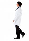 image of blue sky  - Male doctor walking isolated over a white background  - JPG 