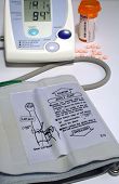pic of bloodpressure  - this is an image of a home blood pressure monitor with a prescription bottle and pills - JPG 