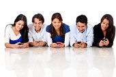 image of group  - Group of people texting on their cell phones  - JPG 