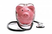 picture of finance  - Piggy bank with stethoscope isolated on white concept for financial checkup or saving for medical insurance costs - JPG 