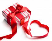 picture of holidays  - holiday gift box with red ribbon in the shape of a heart isolated on white background - JPG 