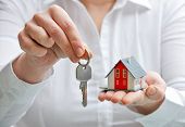 picture of industrial  - Real estate agent with house model and keys - JPG 