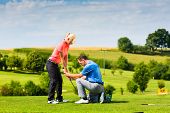 pic of golf  - Young female golf player at Driving Range with a Golf Pro - JPG 