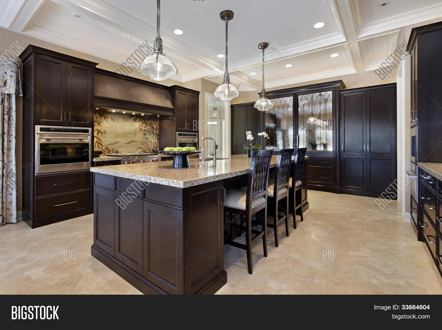 Luxury kitchen in upscale home with dark wood cabinetry Stock Luxury kitchen in upscale home with dark wood cabinetry Stock