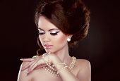 image of beauty  - Beautiful pretty woman with pearls on her neck isolated on dark background - JPG 