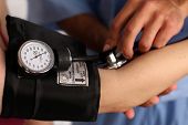 foto of pressure  - Medical worker checking blood pressure - JPG 