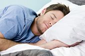 image of comfort  - Man comfortably sleeping in his bed - JPG 