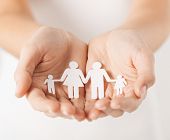 stock photo of future  - close up of womans cupped hands showing paper man family - JPG 