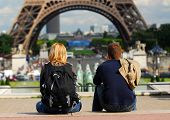 image of france  - Young tourist couple sitting in front of Eiffel tower in Paris France - JPG 