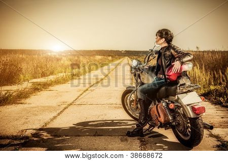 Picture or Photo of Biker girl sits on a motorcycle