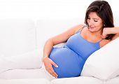 foto of home  - Pregnant woman relaxing at home on the couch - JPG 