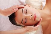 pic of pressure  - Beautiful young relaxed woman enjoy receiving face massage at spa saloon - JPG 