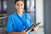 picture of health  - beautiful young female medical intern with tablet computer in office - JPG 