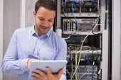 stock photo of wire  - Data centre worker with tablet computer in data centre - JPG 