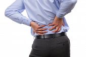 stock photo of bend  - Backache concept bending over in pain with hands holding lower back - JPG 