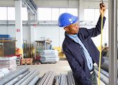 pic of construction worker  - Portrait of a worker using a tape - JPG 