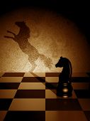 stock photo of surreal  - Black knight with an art shadow as a wild horse - JPG 