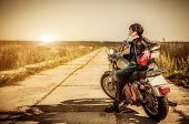 stock photo of outdoor  - Biker girl sits on a motorcycle - JPG 