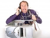 image of computer  - irritated businessman having computer problems phoning hotline - JPG 