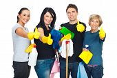 picture of teamwork  - Successful cleaning people teamwork giving thumbs up and holding products for clean house - JPG 