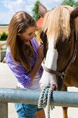 stock photo of horse  - Young woman in the stable or willow with horse at sunshine - JPG 
