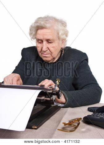 Picture or Photo of Old lady working an old-fashioned way with typewriter