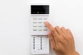 foto of setting  - Hand is setting home security alarm system - JPG 
